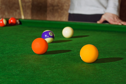 Close up billiards ball on the table and part man body